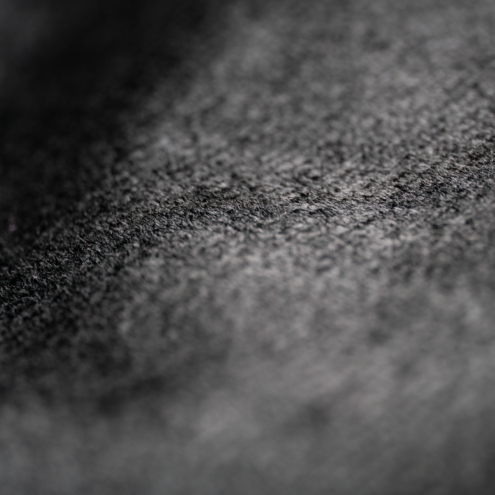 Macro shot showcasing the intricate texture of black fabric material.