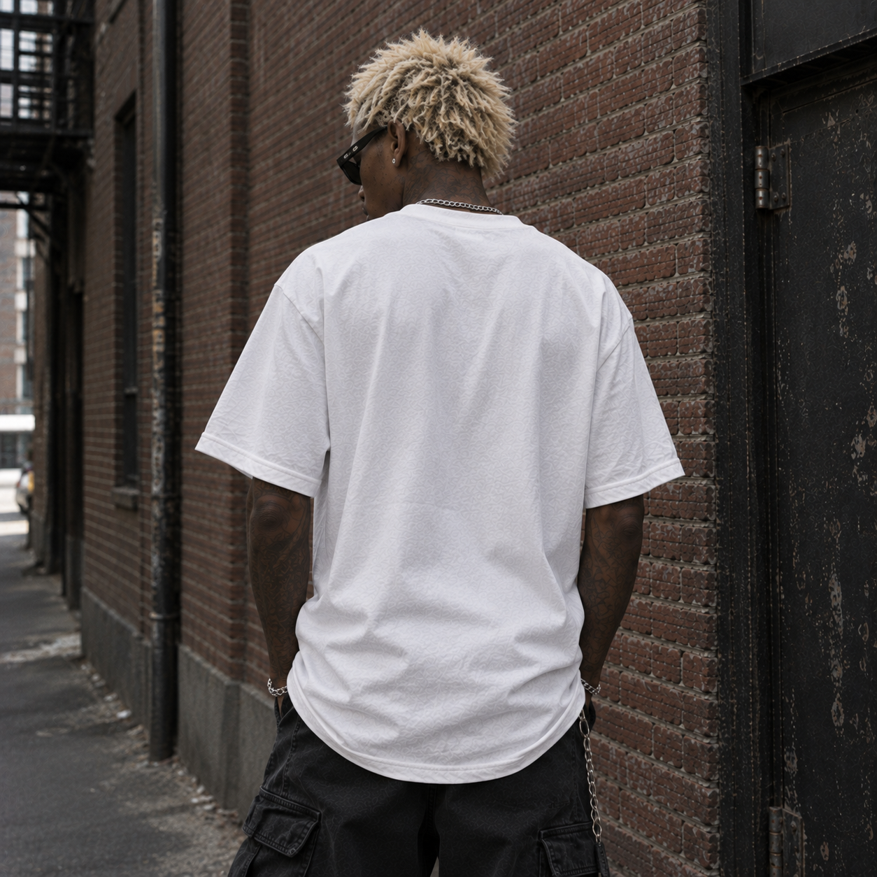Model wearing white dystopian streetwear tee, back view