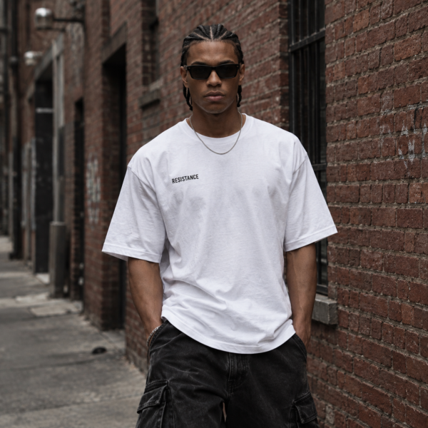 Model wearing white minimalist streetwear tee, front view