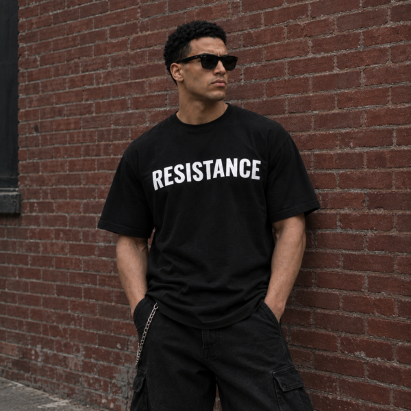 Model wearing black full chest logo streetwear tee, front view