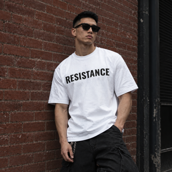 Model wearing white full chest logo streetwear tee, front view
